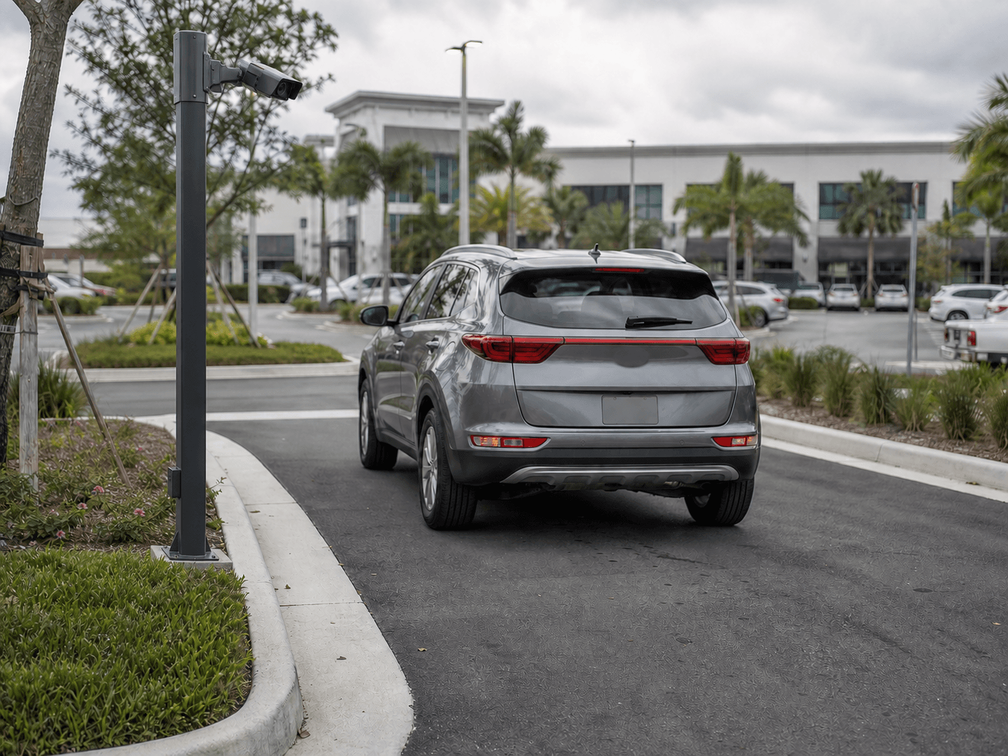 Free-flow license plate recognition camera monitoring an open parking entrance